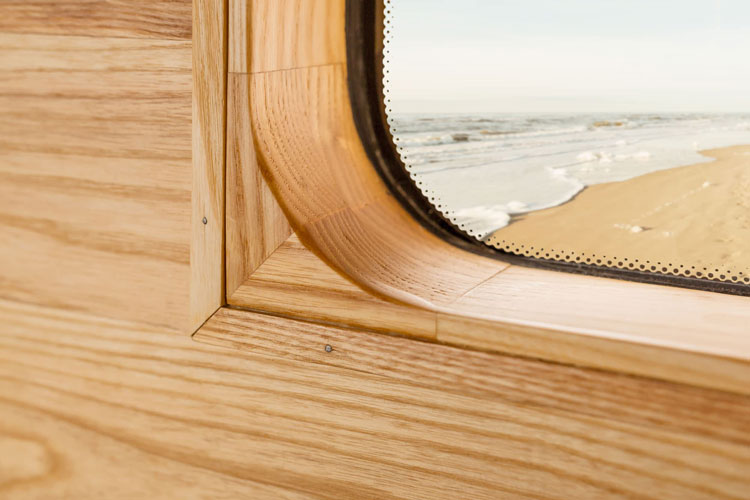 Wooden campervan window framing with round corners. Solid wood. Detail view.